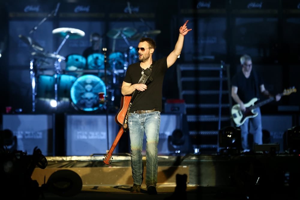 Eric Church holding a guitar and singing