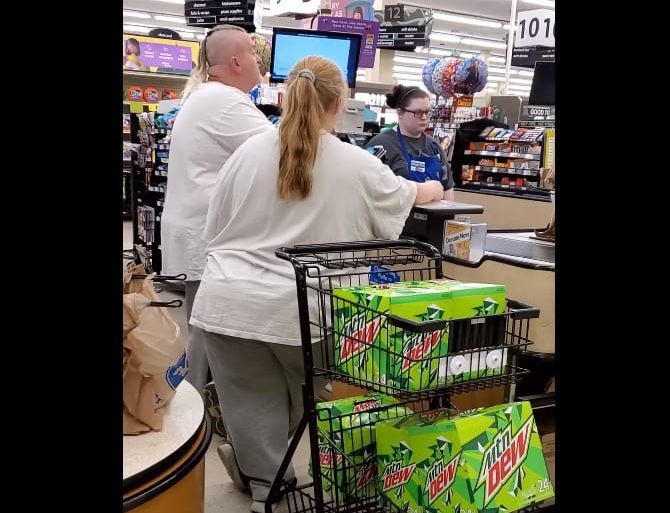 A woman pushing a shopping cart