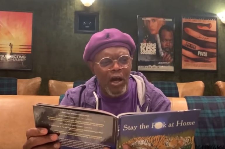 Samuel L. Jackson wearing glasses and holding a book