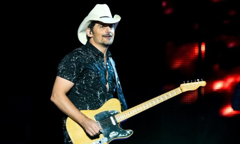 Brad Paisley with a cowboy hat and a guitar