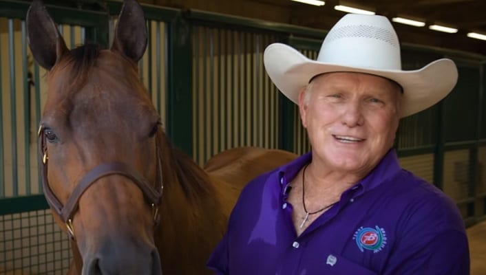 Terry Bradshaw wearing a cowboy hat and a horse
