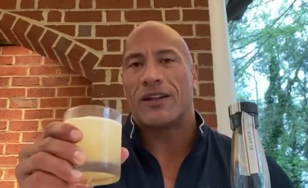 Dwayne Johnson holding a glass of beer