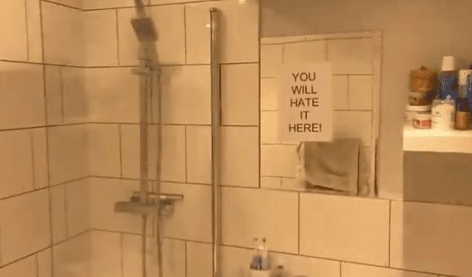 A shower with a sign on it