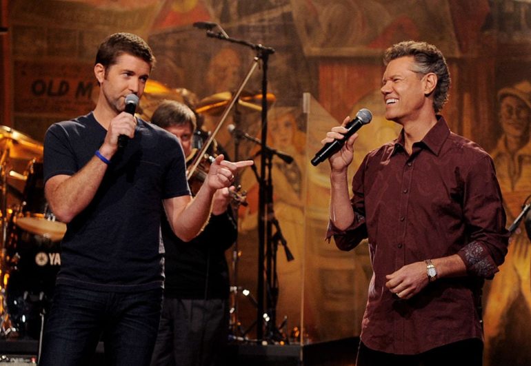 Josh Turner, Randy Travis are posing for a picture