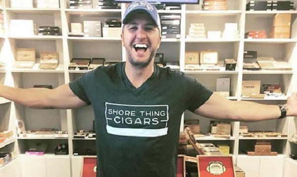 Luke Bryan with his arms out