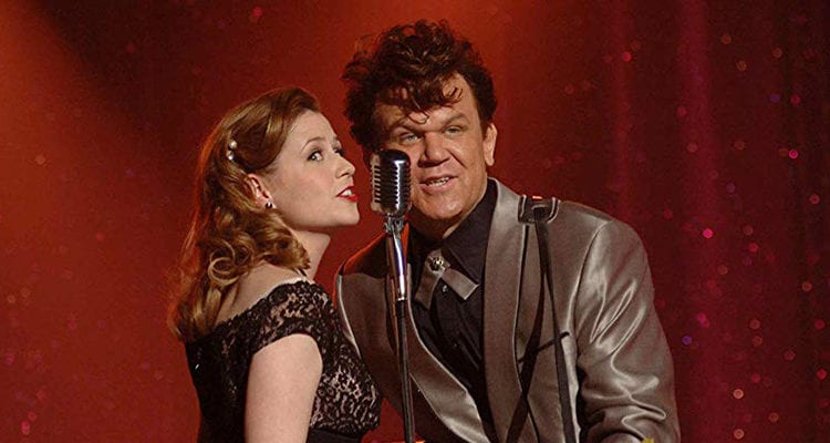 John C. Reilly and woman standing next to each other and smiling