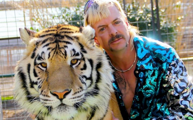 Christopher Hogwood smiling next to a tiger