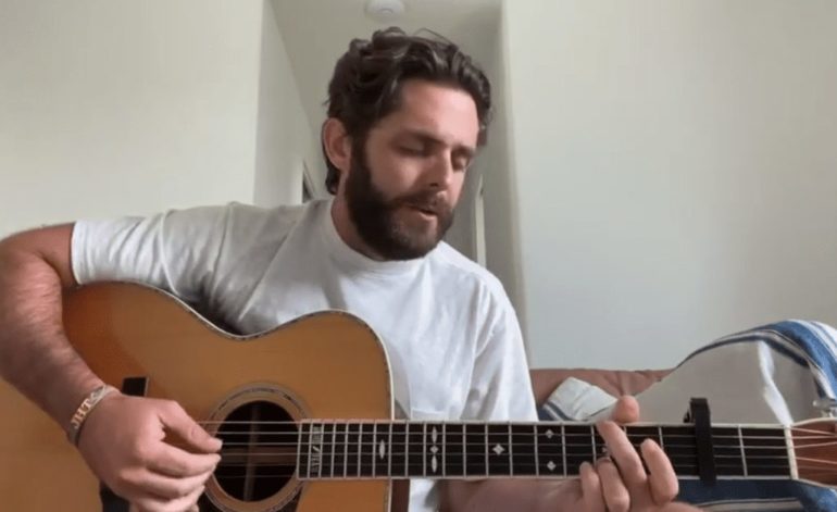 Thomas Rhett playing a guitar