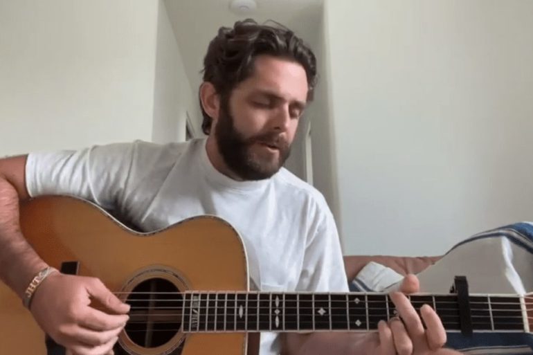 Thomas Rhett playing a guitar