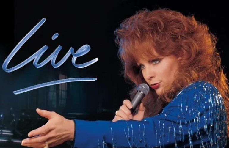 Reba McEntire singing into a microphone