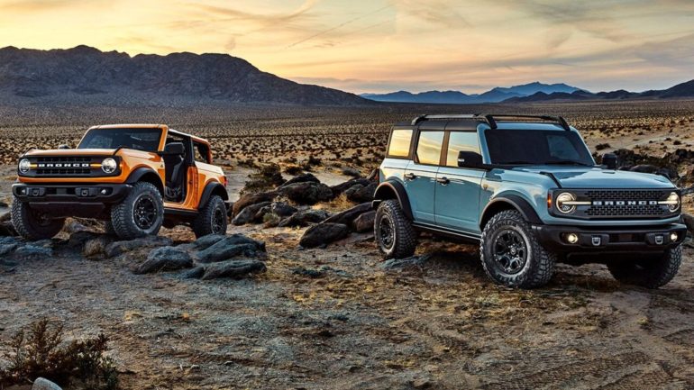 Two jeeps parked in a rocky area