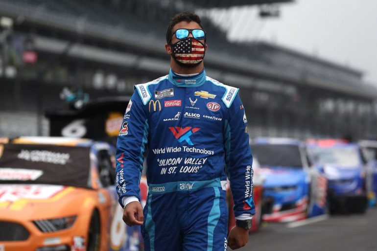A man wearing a racecar outfit