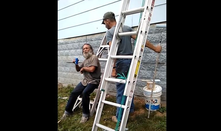 A man and a woman holding a ladder