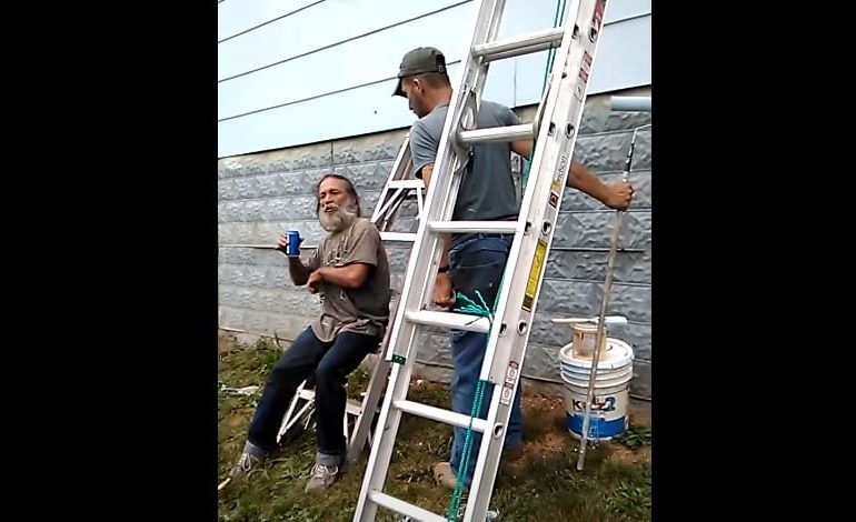 A man and a woman holding a ladder