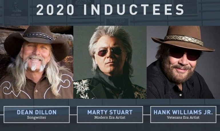 Hank Williams Jr., Marty Stuart are posing for a picture