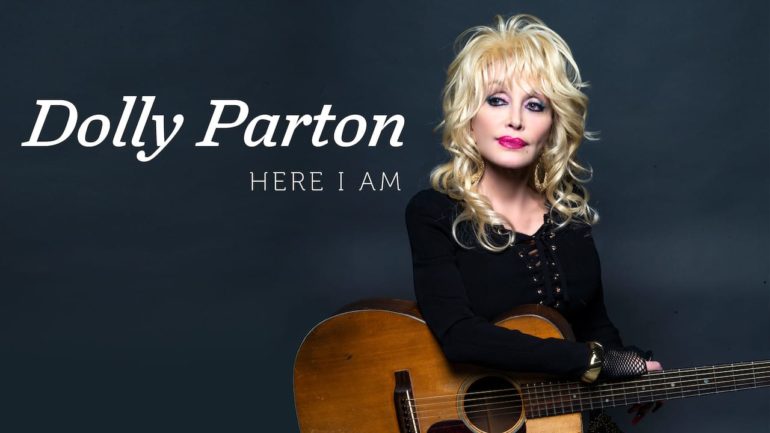 Dolly Parton holding a guitar