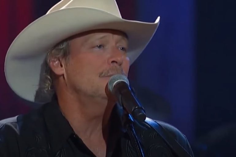 Alan Jackson wearing a white hat and a white hat with a microphone