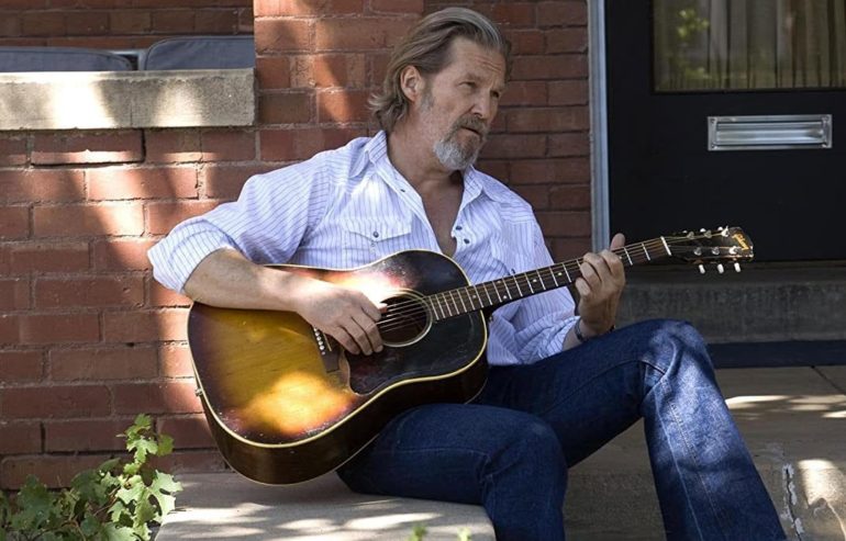 Jeff Bridges playing a guitar