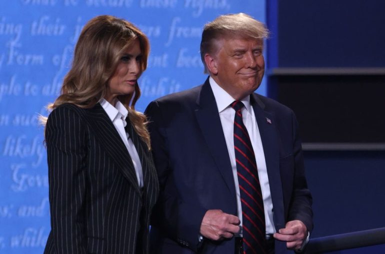 Donald Trump and woman standing next to each other