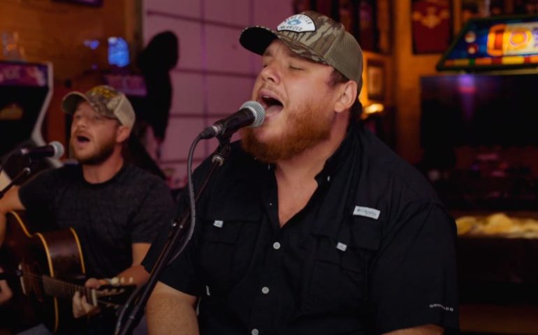 Luke Combs singing into a microphone