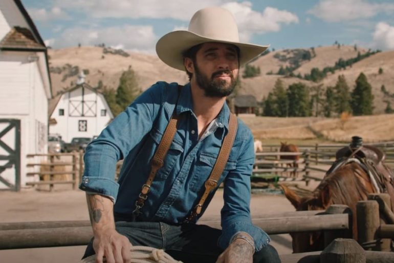 A man in a cowboy hat sitting on a horse