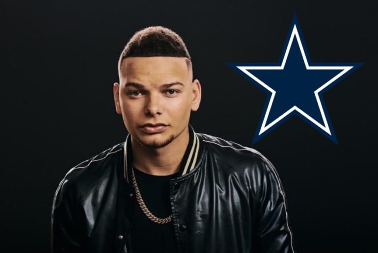 Kane Brown with a necklace and a flag in the background