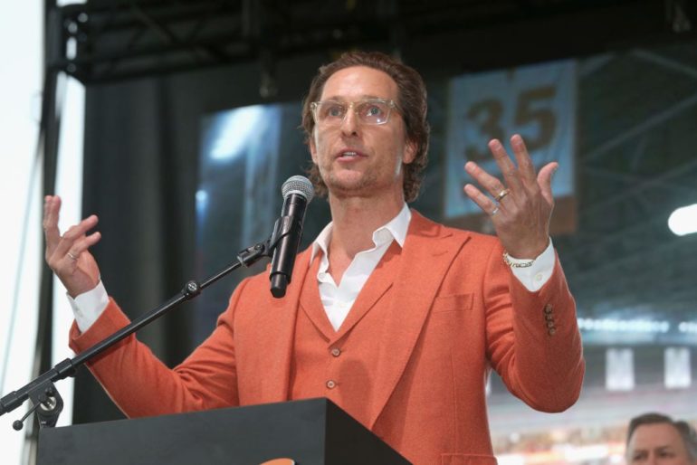 Matthew McConaughey holding a mic