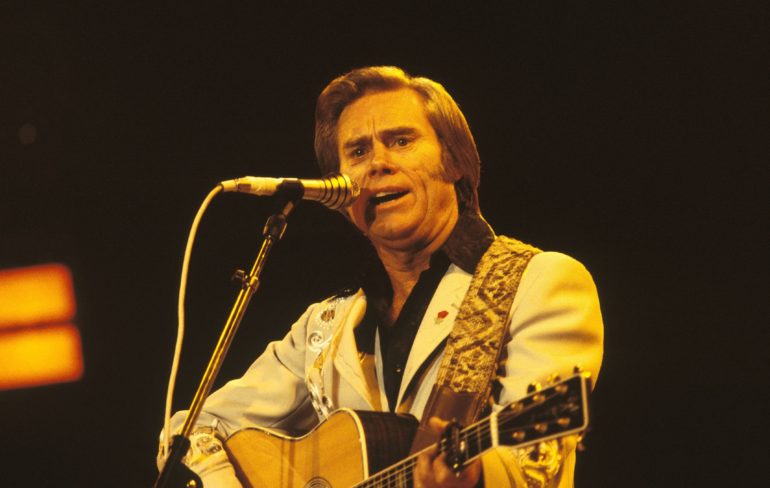 George Jones playing a guitar