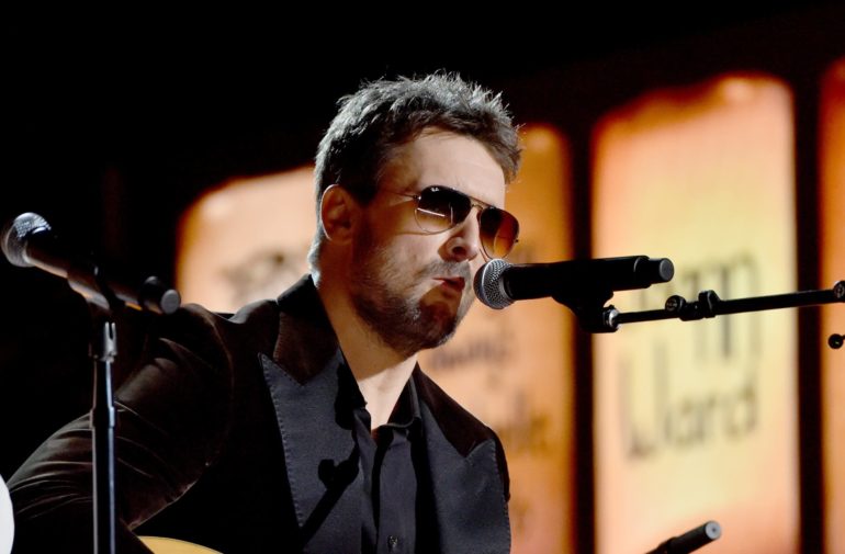 Eric Church with glasses and a microphone