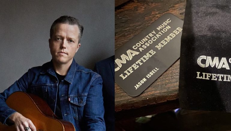 Jason Isbell sitting in front of a book