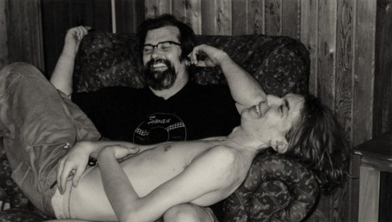 Steve Earle and woman lying on a couch