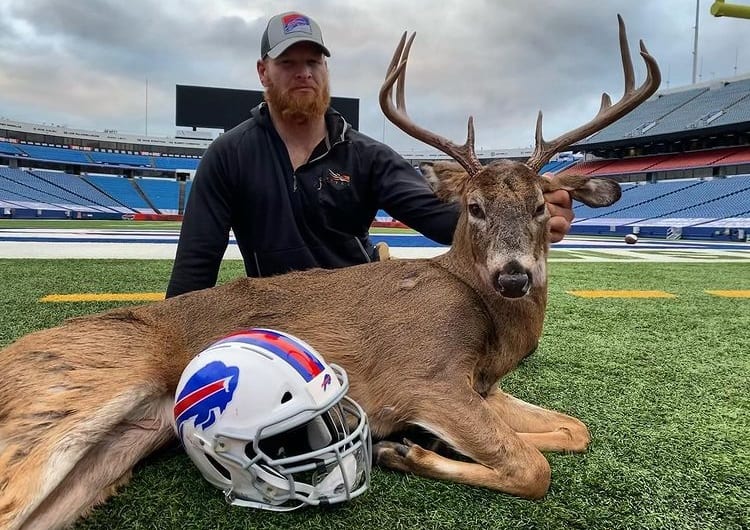 Trent Murphy holding a large animal