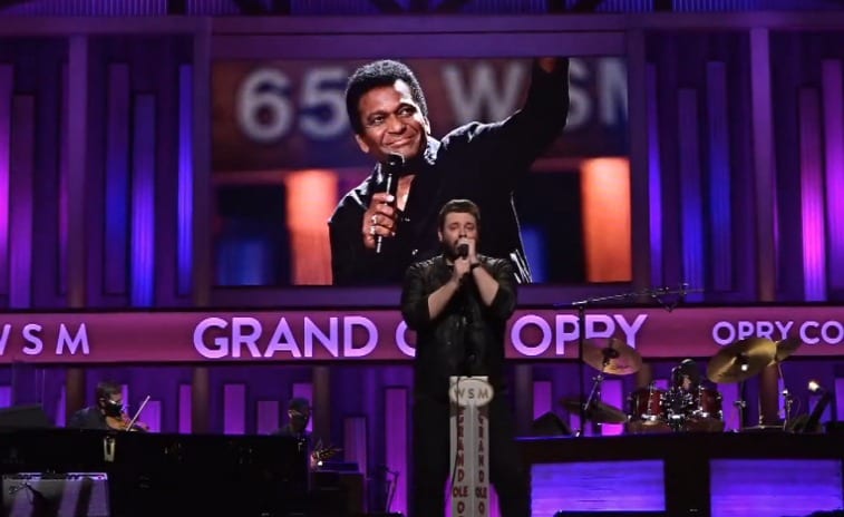 Charley Pride holding a microphone