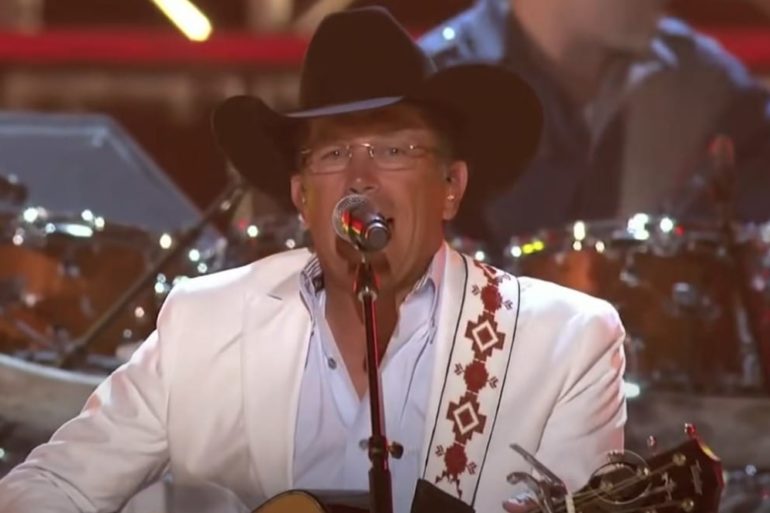 A man wearing a cowboy hat and holding a microphone