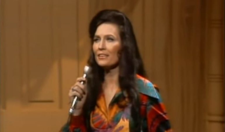 Loretta Lynn holding a microphone