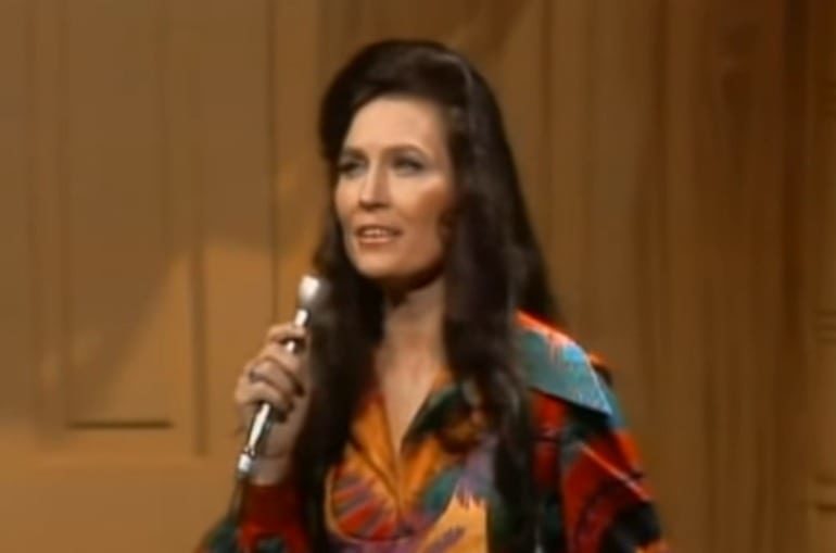 Loretta Lynn holding a microphone