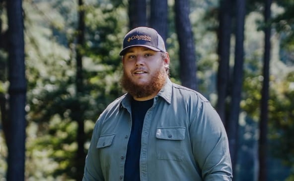 Luke Combs wearing a hat and tie