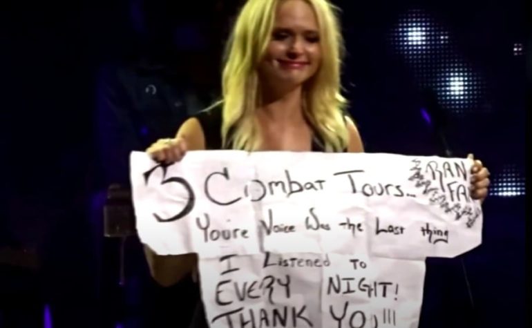 Miranda Lambert holding a sign