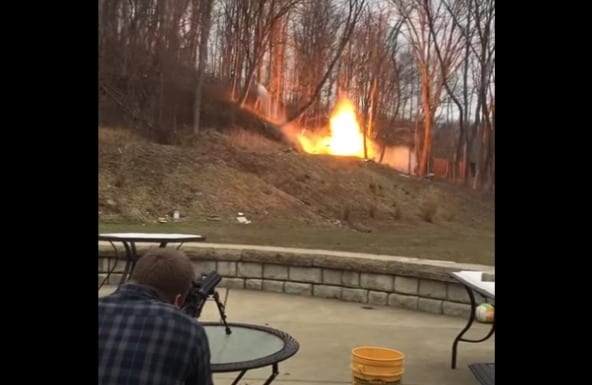 A person sitting in a chair in front of a fire