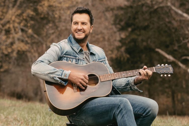 Luke Bryan playing a guitar