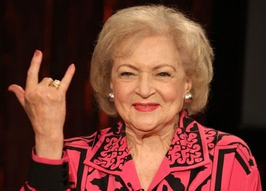 Betty White with her hand up