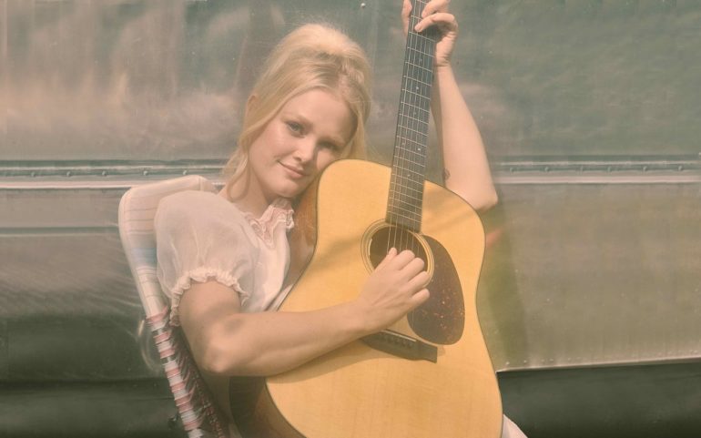 A woman playing a guitar