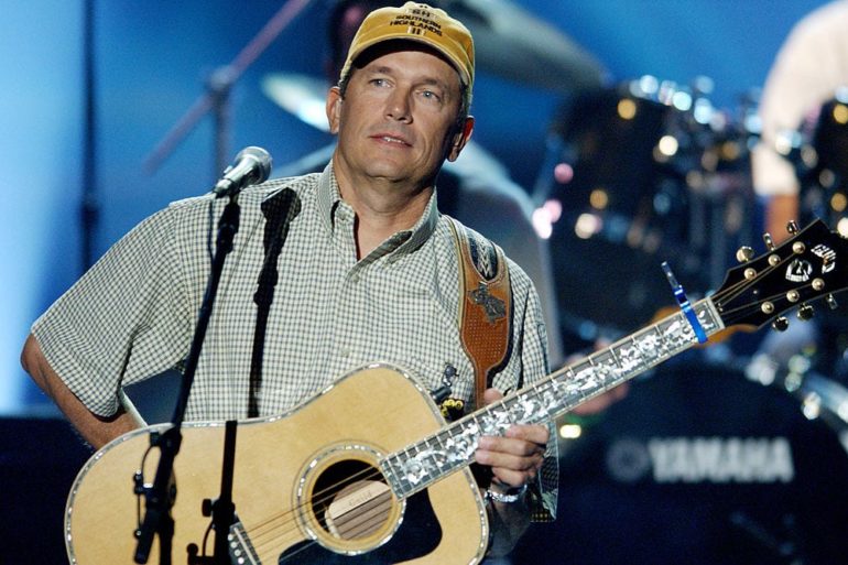 George Strait playing a guitar