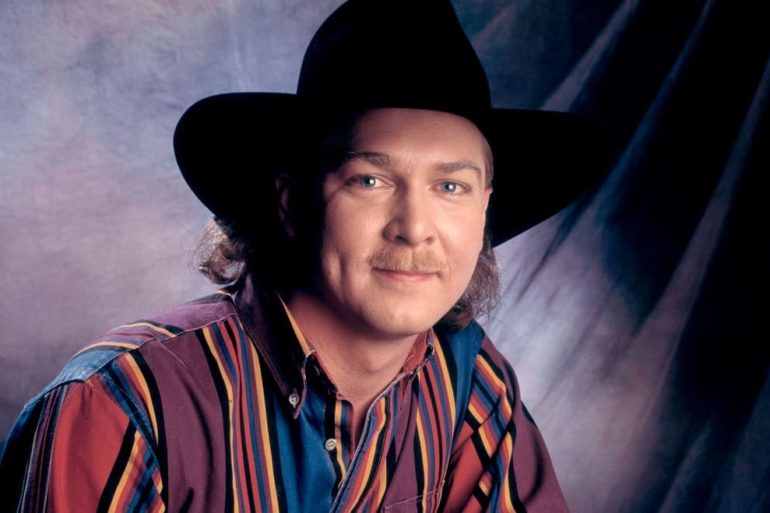 Tracy Lawrence wearing a black hat