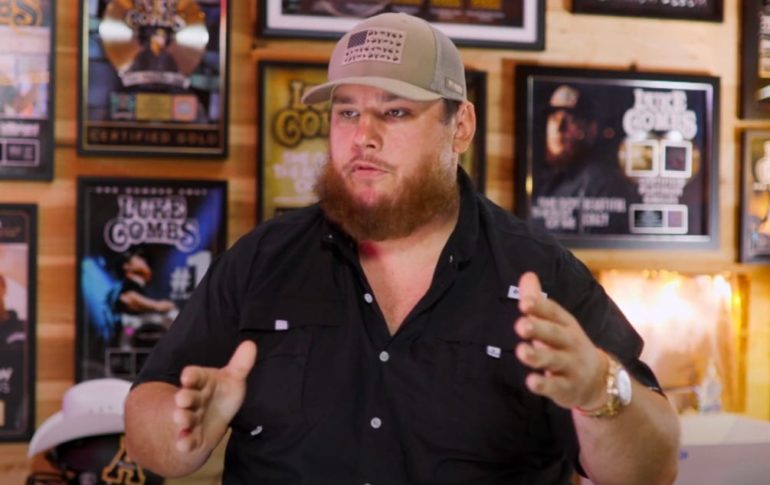 Luke Combs wearing a hat and pointing