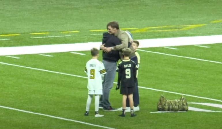 A person and a boy on a football field