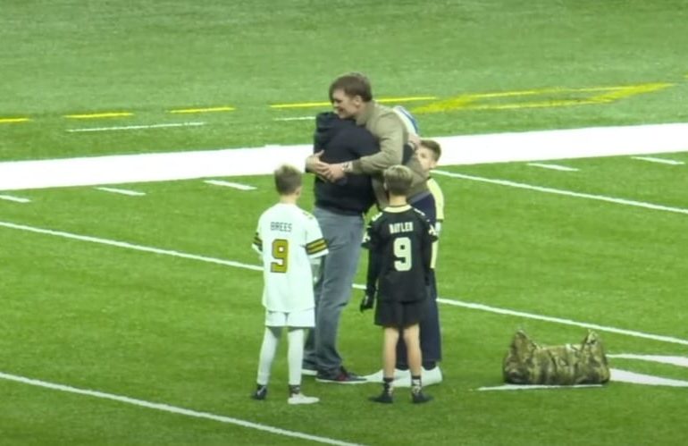 A person and a boy on a football field