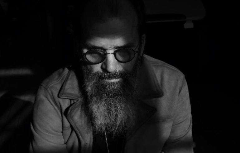 A man with a beard and glasses
