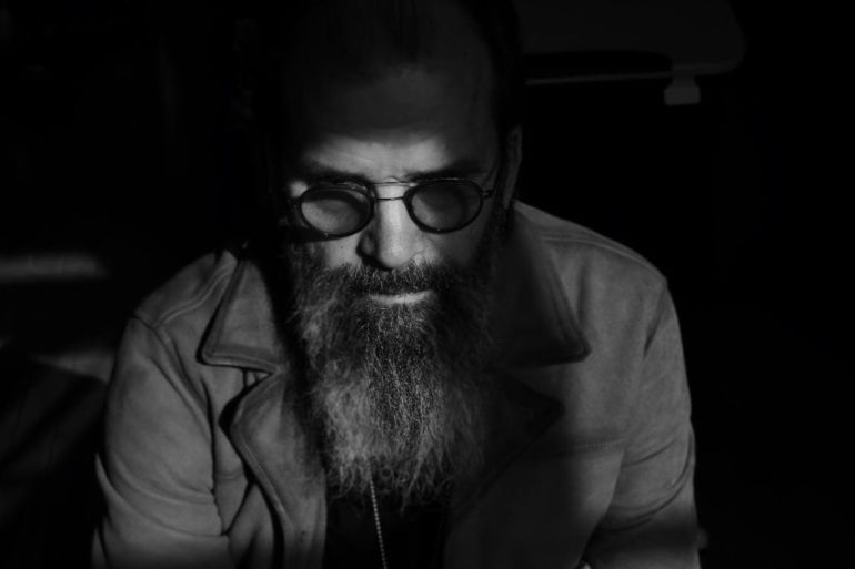 A man with a beard and glasses