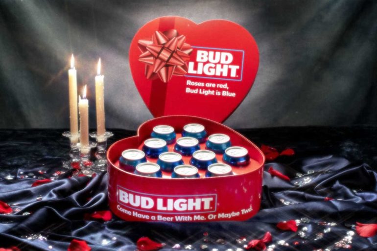 A red and white box with candles and a red heart on a black background